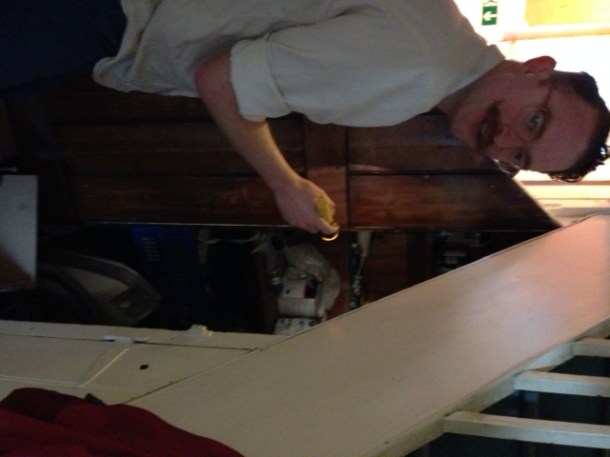 Ed looking in a cupboard for cleaning products